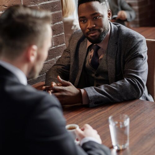 Businessmen Having a Meeting at a Cafe