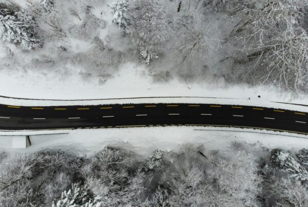 an aerial view of a road surrounded by snow