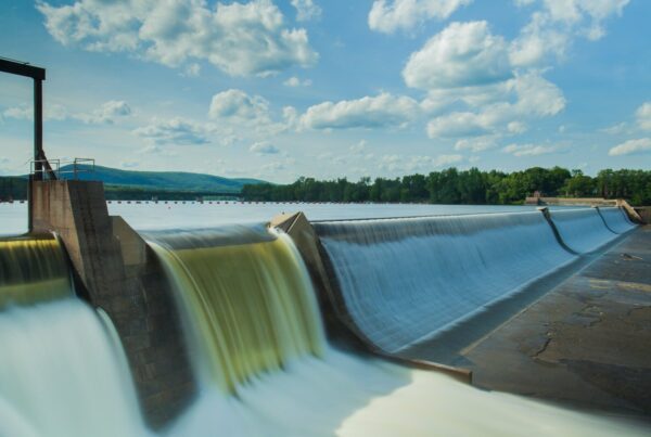 water dam under white and blue skies